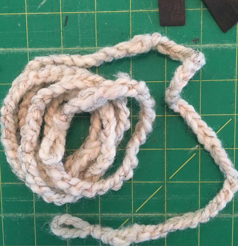 Close up of creamy white crocheted yarn garland