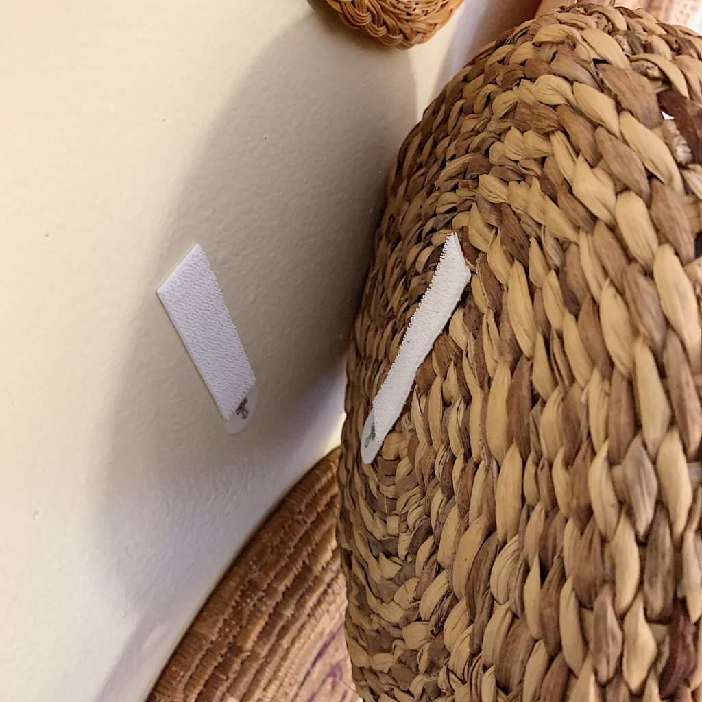 Close up showing how to attach a basket to the wall using 3m command strips