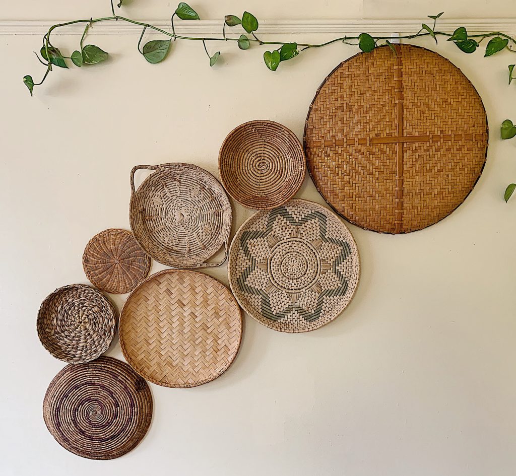 Vintage baskets grouped on large wall