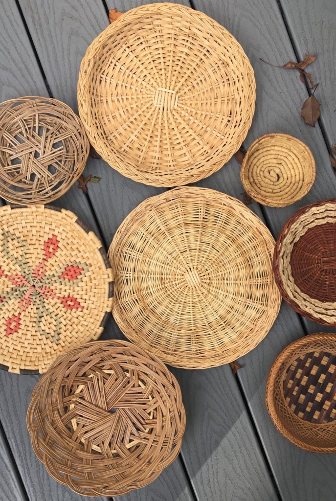 Closeup of eight vintage round baskets covering an area of deck