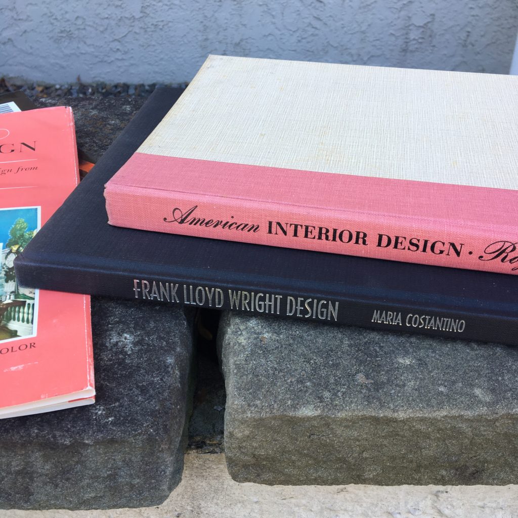 thrifted hard cover design books on stone ledge