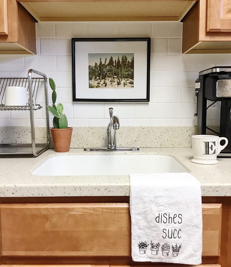 Small cactus framed print above sink with cactus, anthropologie mug and etsy dish towel