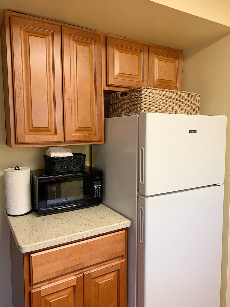 small apartment campus housing kitchen with storage baskets
