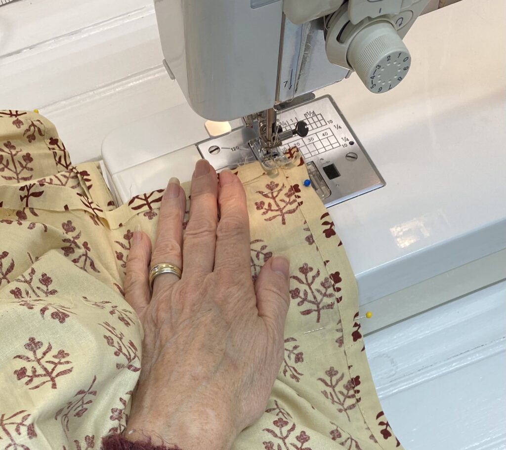 close up of sewing machine sewing curtain panels together