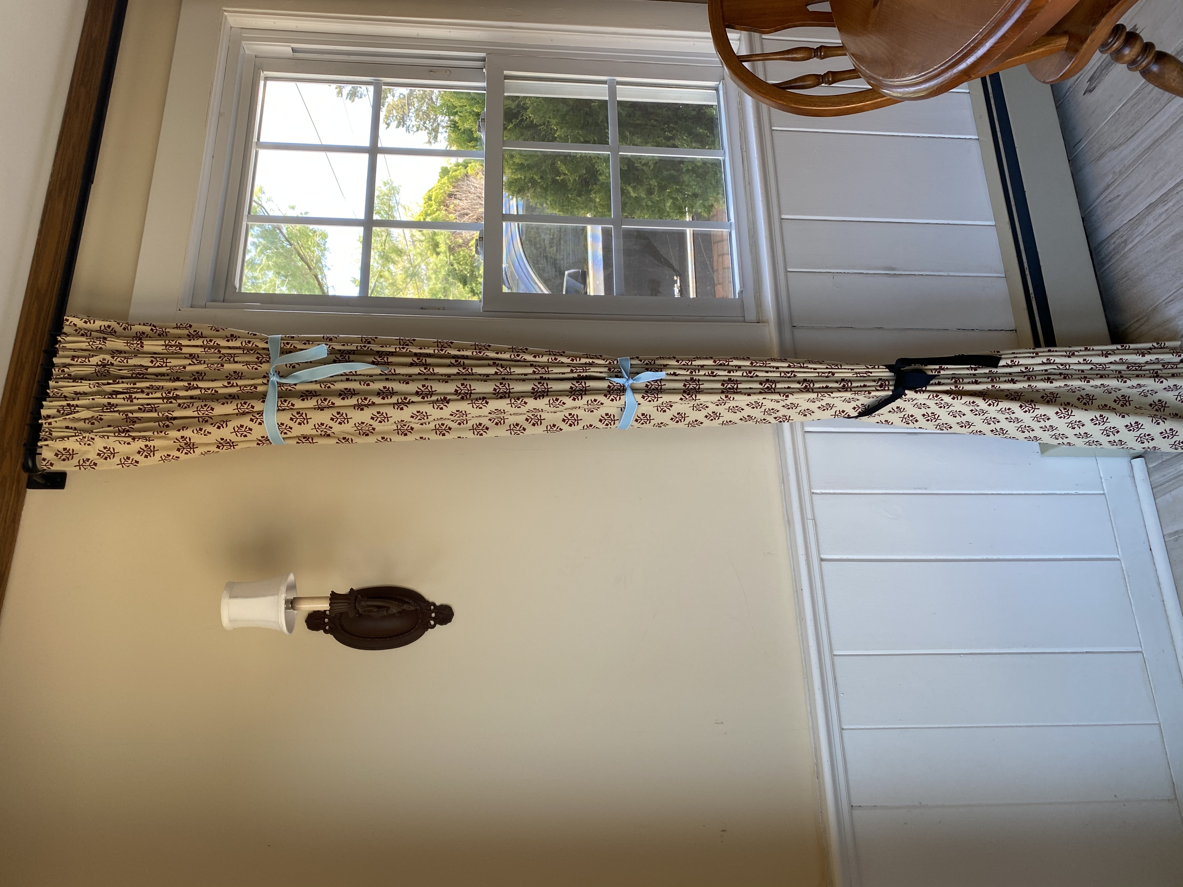 kitchen with ditsy print drape tied in three spots with ribbon to set pleats