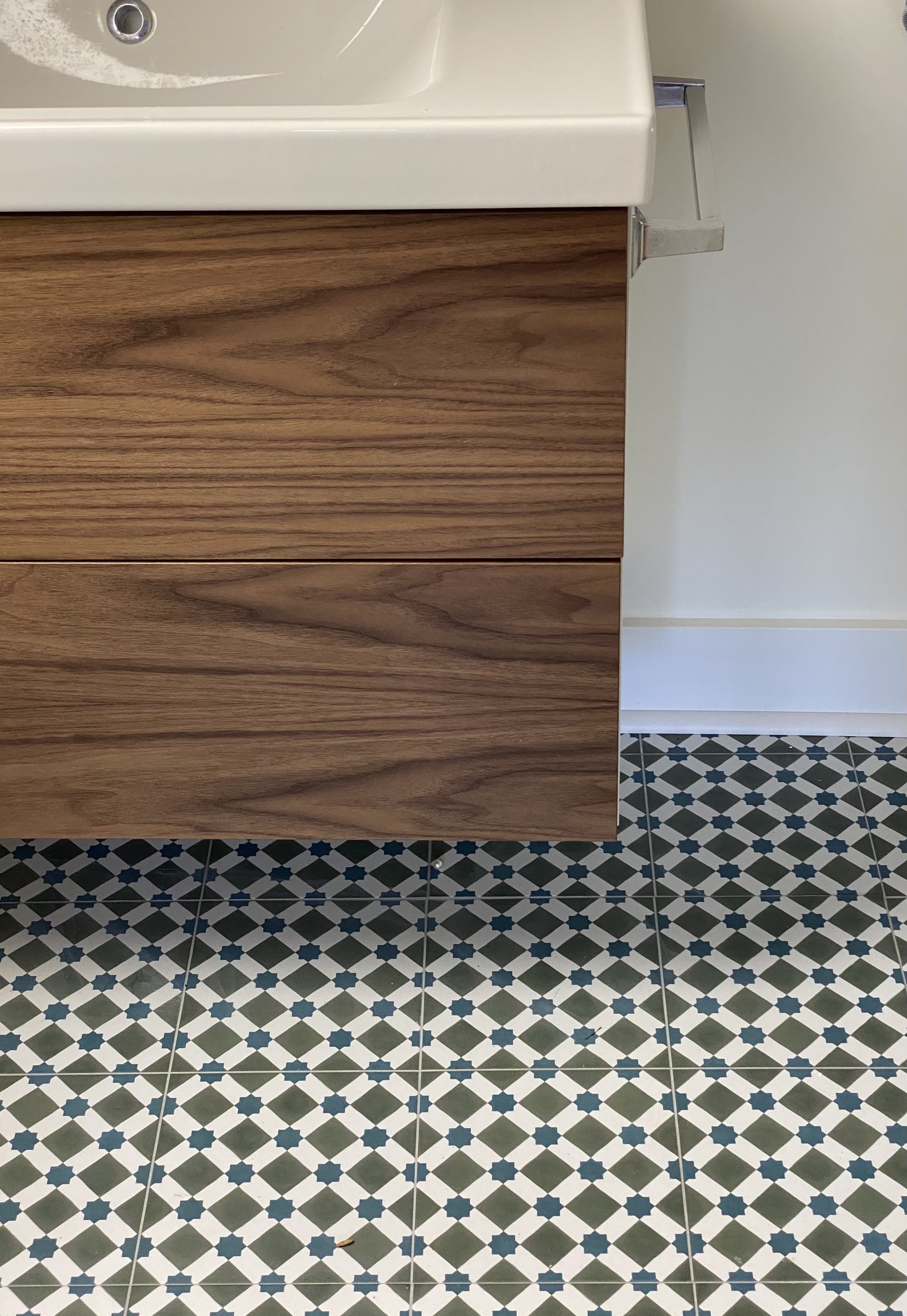 blue and green patterned floor tile with walnut front Ikea vanity