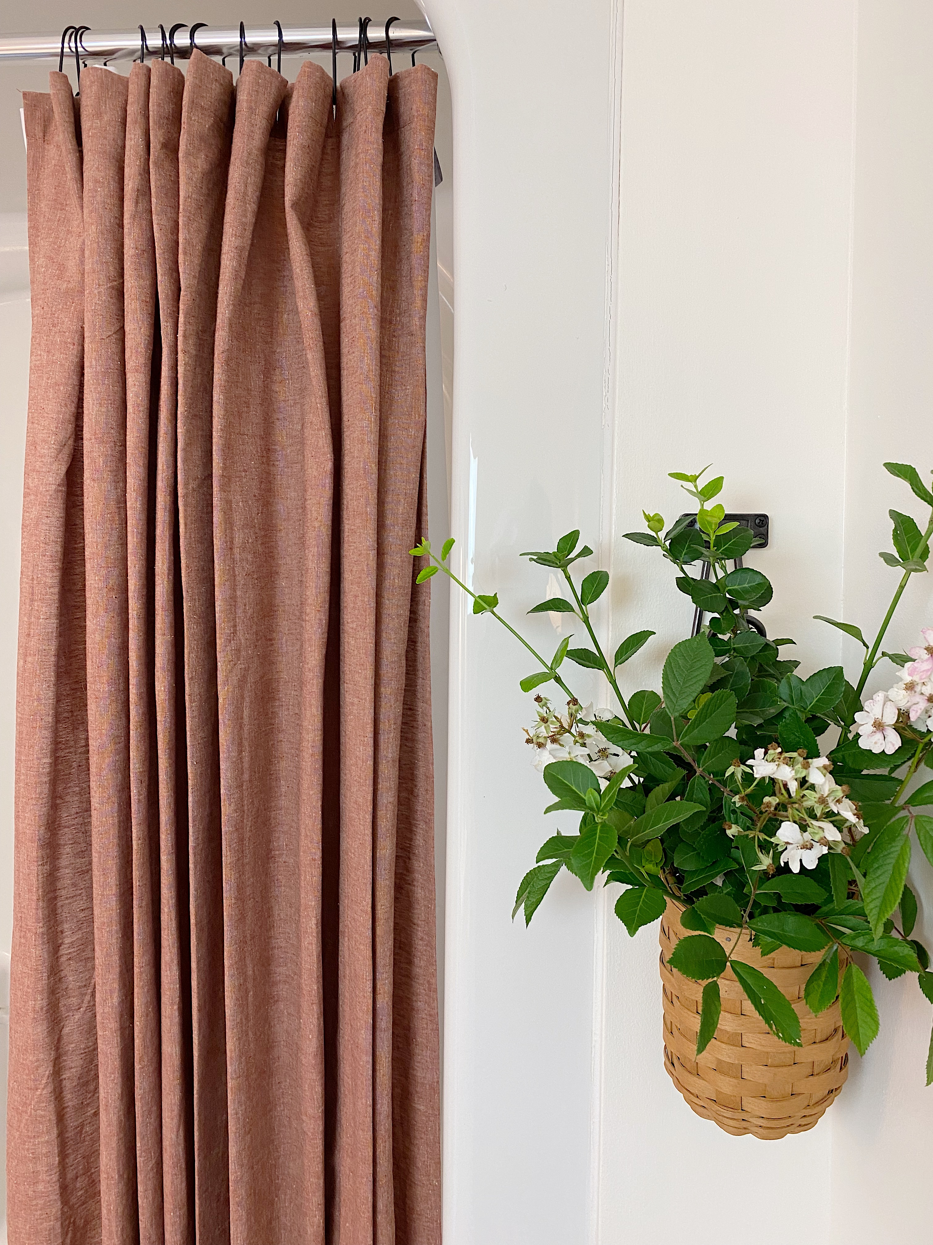 terracotta linen shower curtain with flowers in wall basket