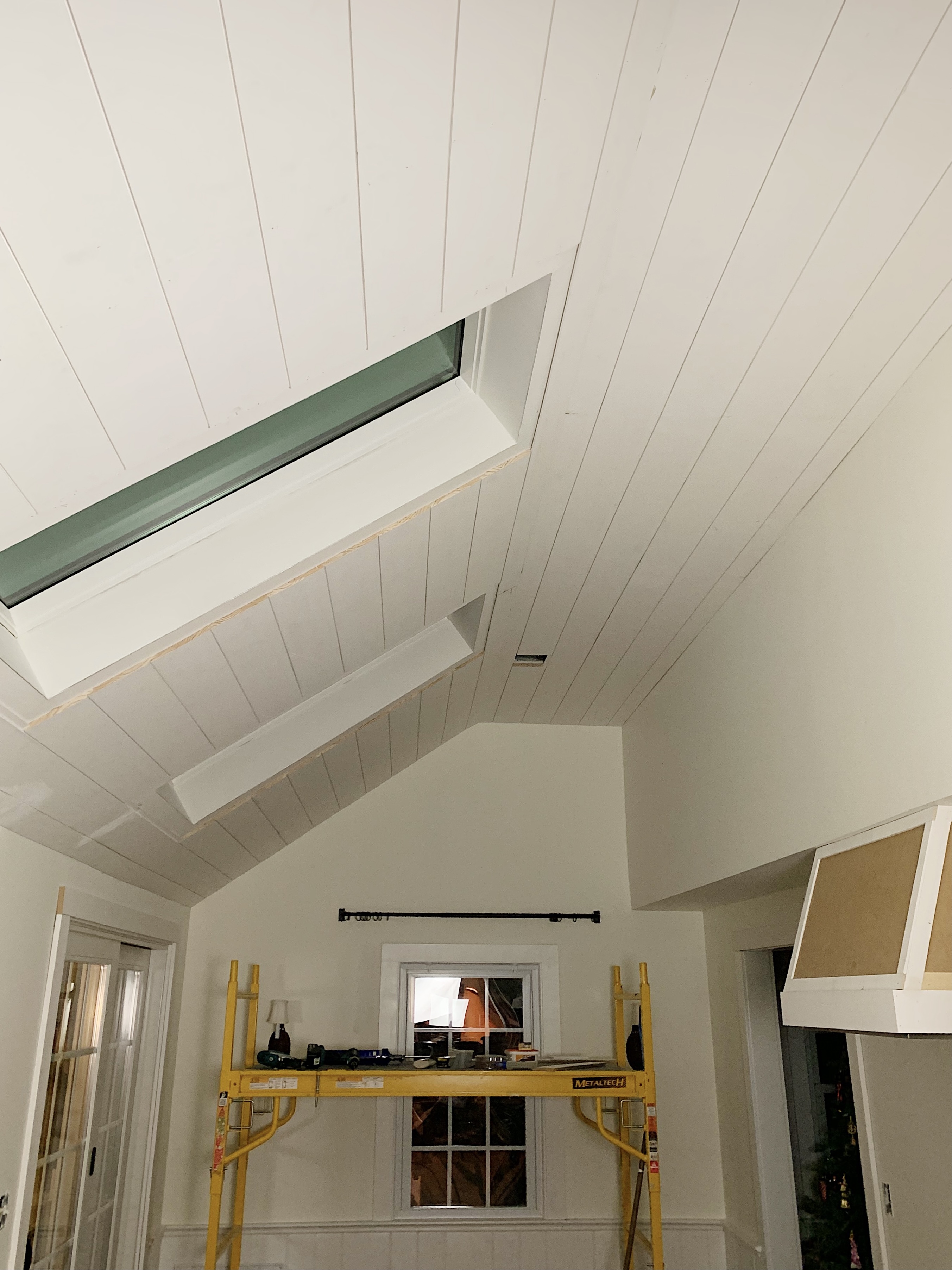 shiplap on vaulted ceiling with skylight