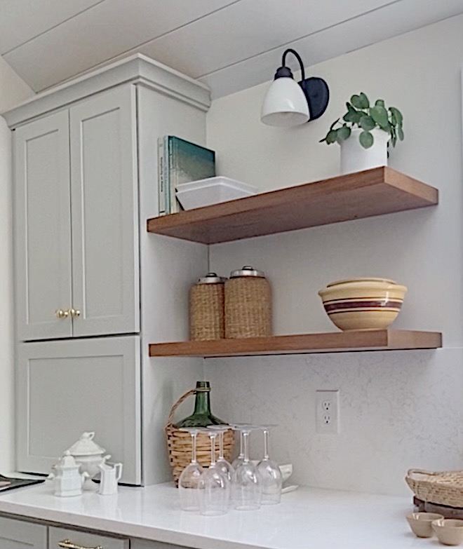 stained wood floating shelves with gray kitchen cabinets