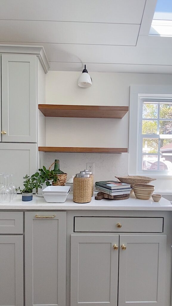 stained floating shelves with gray kitchen cabinets
