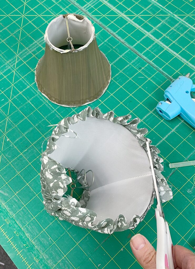 trimming excess fabric from bottom of lampshade