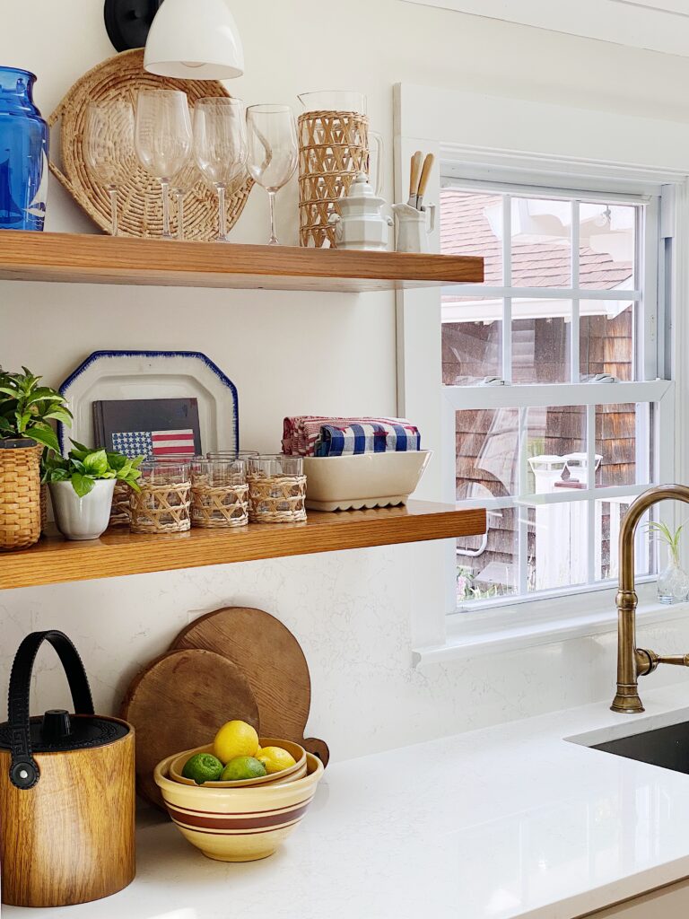 Oak kitchen shelves styled for summer with vintage red, white and blue dishes